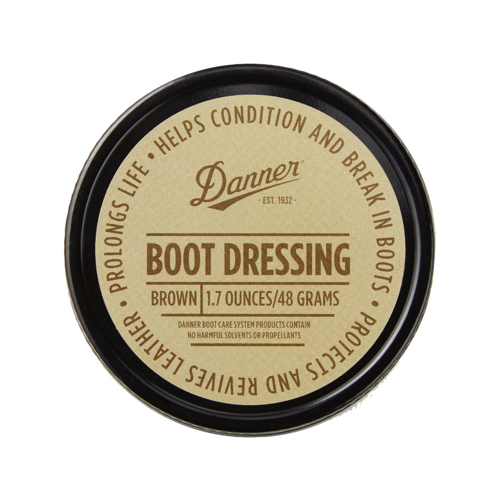 A container of Danner Boot Dressing, premium leather conditioner, with the lid off, showing the white cream inside.