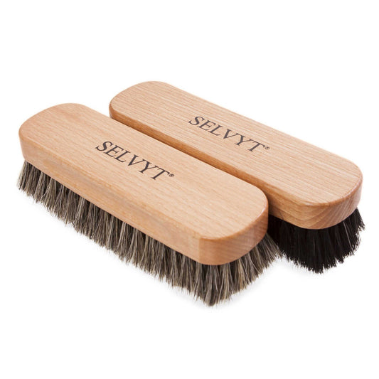 Two wooden-handled Selvyt buffing brushes with horsehair bristles, lying flat.