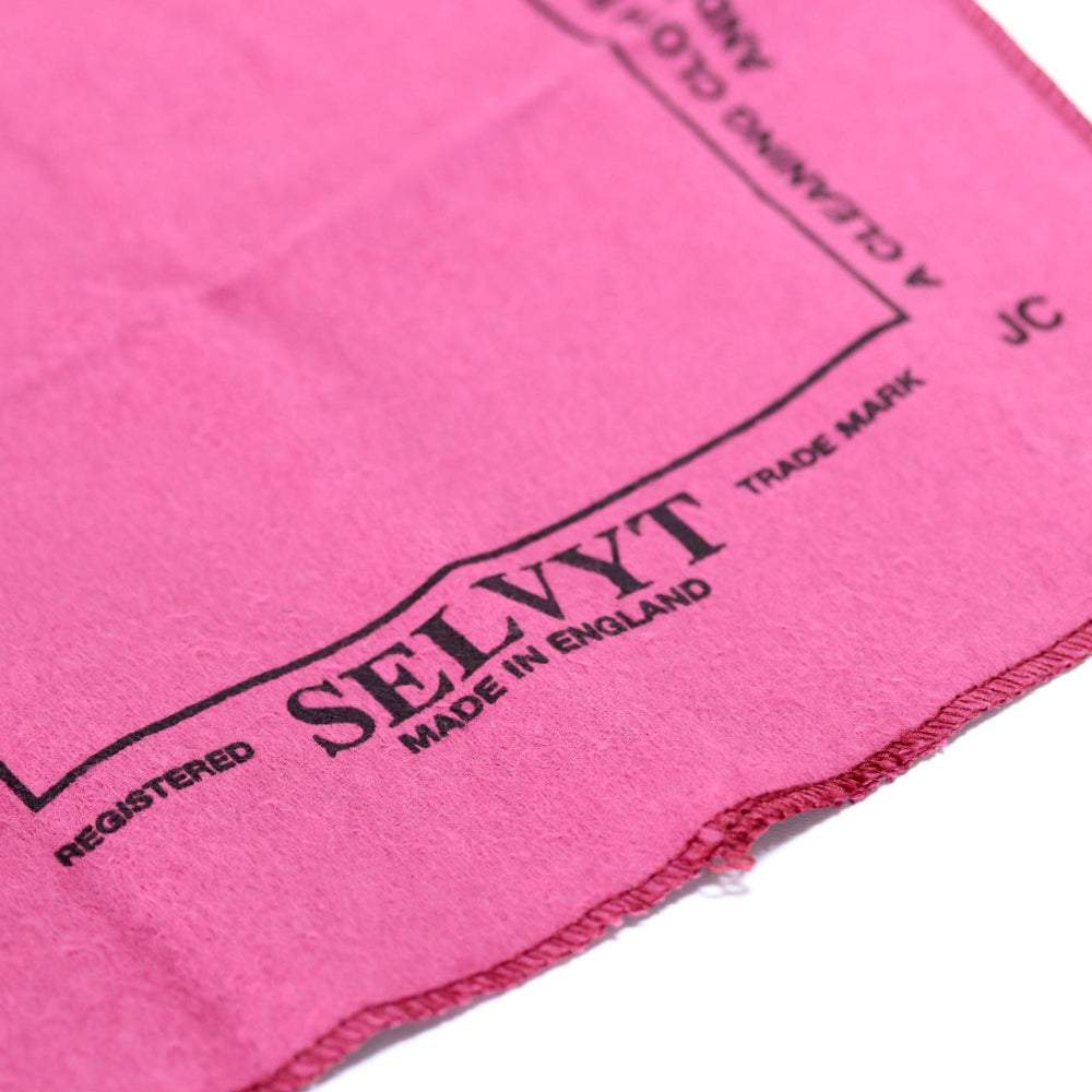 Close-up of a pink towel with SELVYT branding on a white background