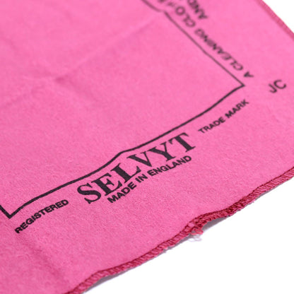 Close-up of a pink towel with SELVYT branding on a white background