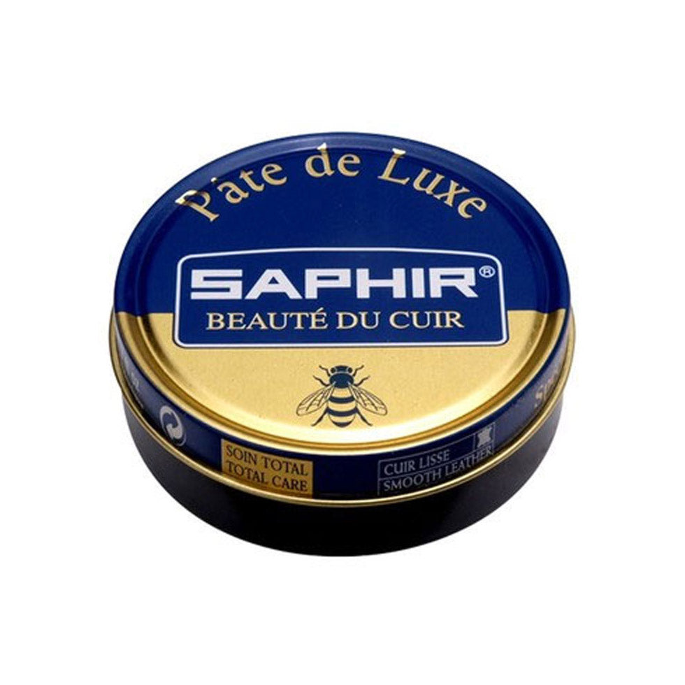 Three containers of Saphir Pate de Luxe wax shoe polish, with the brand's logo and the words 'Beauty of Leather' displayed on the lids.
